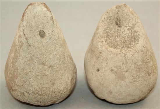 A pair of Greek stone loom weights, c.3rd century BC, 8.5cm and 9.5cm